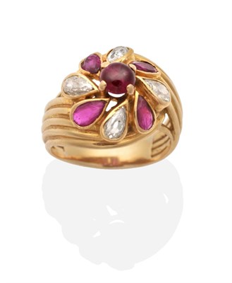 Lot 223 - A French Ruby and Diamond Cluster Ring, a round cabochon ruby in a claw setting, within a border of