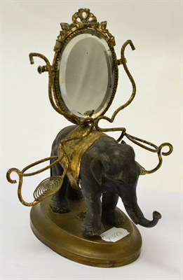 Lot 298 - A small bronze model of an elephant, the brass howdah cast as faux bamboo with ribbon tied...