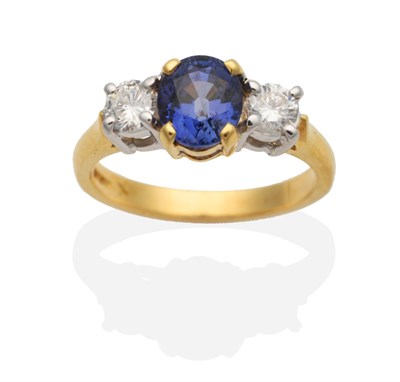 Lot 231 - An 18 Carat Gold Sapphire and Diamond Three Stone Ring, an oval cut sapphire in a claw setting,...