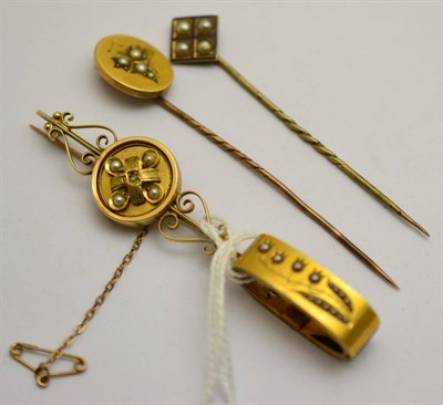 Lot 380 - Two pearl set stick pins, a scarf pin and a pearl set bar brooch