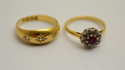 Lot 381 - An 18ct gold diamond three stone ring and a cluster ring (2)