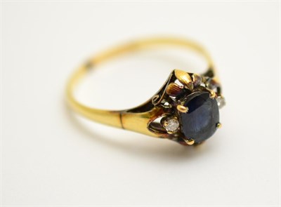 Lot 399 - A sapphire and diamond three stone ring, stamped '585'