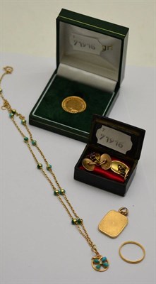 Lot 419 - A 2014 full sovereign together with a Victorian unmarked yellow metal and amethyst pendant, a...