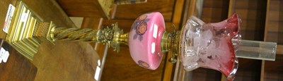 Lot 421 - A Victorian oil lamp with brass Corinthian column, pink glass font and an etched cranberry shade