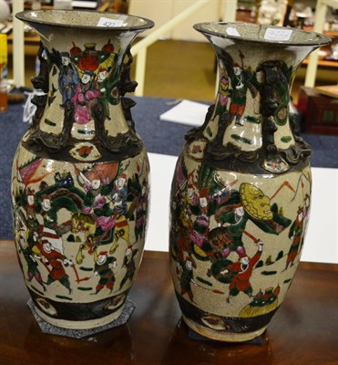 Lot 422 - A pair of Chinese vases, decorated with warriors (a.f.)