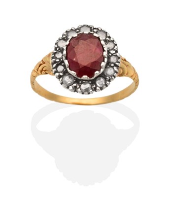 Lot 243 - An Antique Ruby and Diamond Cluster Ring, an oval cut ruby in a collet setting, within a border...