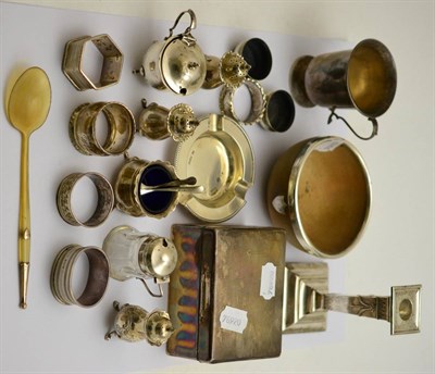 Lot 445 - A group of silver including cigarette box, salts, pepperettes, candlestick, christening mug, silver