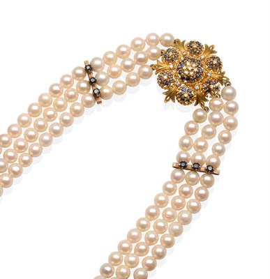 Lot 247 - A Triple Strand Cultured Pearl Necklace, with an 18 Carat Gold Sapphire and Diamond Clasp,...