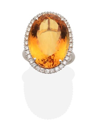 Lot 257 - An 18 Carat White Gold Citrine and Diamond Cluster Ring, an oval cut citrine in a claw setting,...