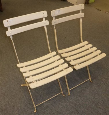 Lot 1083 - Two French white painted folding chairs