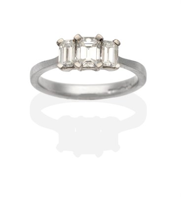 Lot 261 - A Platinum Diamond Three Stone Ring, graduated octagonal cut diamonds in claw settings, to...
