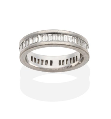 Lot 266 - An 18 Carat White Gold Diamond Eternity Ring, channel set with baguette cut diamonds, total...