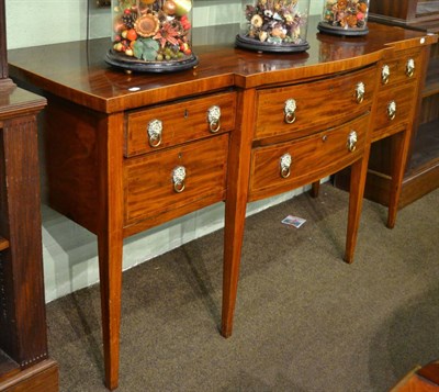 Lot 1200 - A mahogany breakfront bow fronted sideboard, the drawers fitter with ring and lion mask pulls