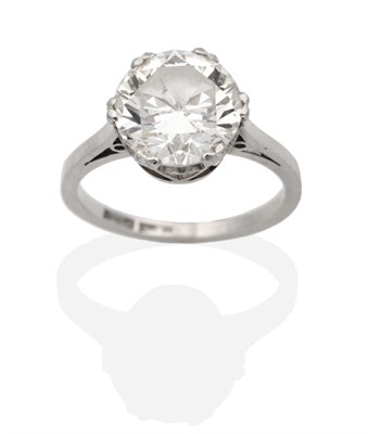 Lot 275 - A Solitaire Diamond Ring, a round brilliant cut diamond in a double claw setting, to knife edge...