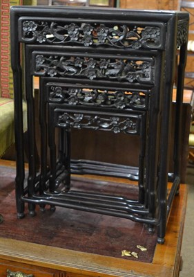 Lot 1225 - A nest of four Chinese carved and ebonised occasional tables