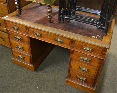 Lot 1227 - An early 20th century walnut pedestal desk with red leather top