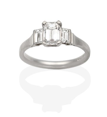 Lot 278 - A Platinum Three Stone Diamond Ring, an octagonal cut diamond in a claw setting, spaced by baguette