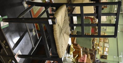 Lot 1239 - An ebonised cafe chair, the shaped top rail, above an extending lattice back to lower...