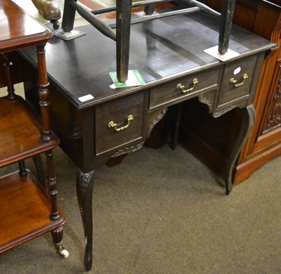 Lot 1240 - An Edwardian ebonised writing table with three drawers