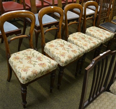 Lot 1267 - A set of four oak framed balloon back dining chairs with floral covered seats