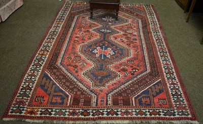 Lot 1284 - Kashgai rug, South West Persia, the faded rose pink field with four linked stepped medallions...