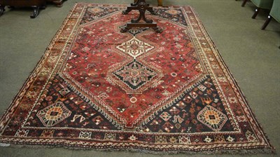 Lot 1285 - A Kashgai carpet, the blood red ground with geometric medallions