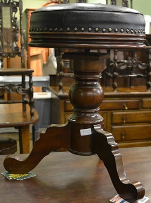 Lot 1292 - A leather and mahogany revolving piano stool