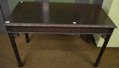 Lot 1322 - A 19th century carved side table, the moulded and carved rectangular top above blind fret work over