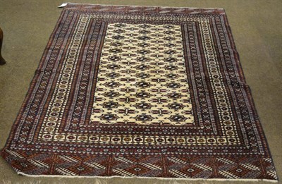 Lot 1324 - A Lahore 'Bukhara' rug, the ivory field with a column of quartered guls enclosed by multiple...