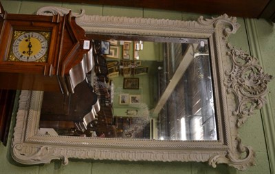 Lot 1330 - A 19th century Rococo style wall mirror, later cream painted and with original distressed...