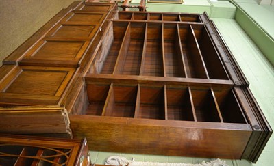 Lot 1332 - A George III style mahogany breakfront library bookcase, the carved rosette and fluted frieze above