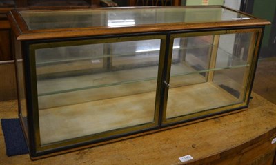 Lot 1339 - An oak and brass framed display case