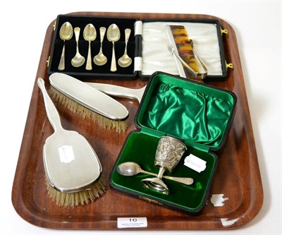 Lot 16 - A four piece silver backed dressing table set, a silver Christening set, six silver spoons and...