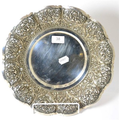 Lot 38 - A Continental white metal dish stamped '800', dragon and thistle design, raised on three ball feet