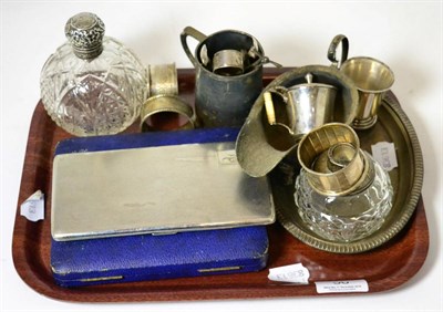 Lot 50 - A silver cigarette case, silver topped glass bottle, two silver salts, three silver napkin rings, a