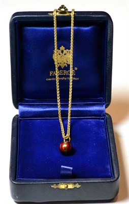 Lot 114 - Enamel egg on chain, the egg stamped '750 Faberge R 15/500' in a case stamped Faberge