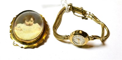 Lot 117 - A 9ct gold Accurist lady's wristwatch, stamped '375' with a plated brooch (2)