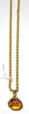 Lot 118 - A citrine coloured swivel fob on 9ct gold rope twist chain, stamped '375'