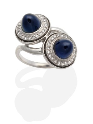 Lot 310 - An Art Deco Sapphire and Diamond Ring, two high dome cabochon sapphires in milgrain settings within