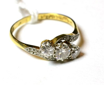 Lot 135 - A diamond three stone twist ring