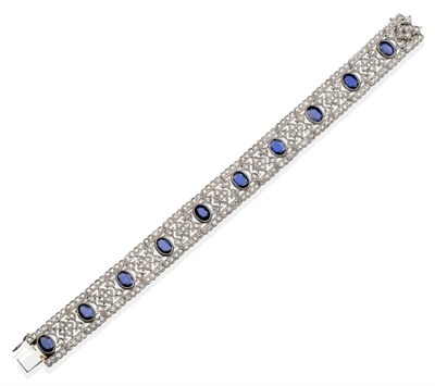 Lot 311 - A Sapphire and Diamond Bracelet, oval cut sapphires in milgrain settings, within pierced round...