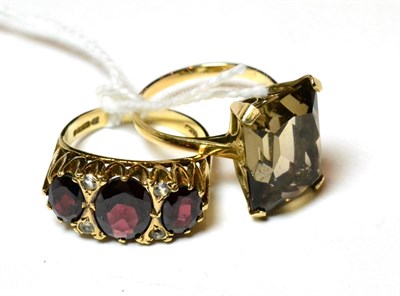 Lot 161 - A 9ct gold smokey quartz ring and a 9ct gold garnet and diamond ring (2)