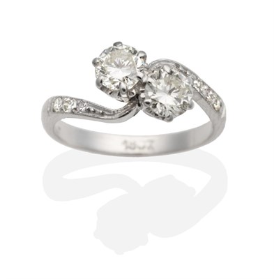 Lot 314 - A Two Stone Diamond Crossover Ring, round brilliant cut diamonds in claw settings to diamond...