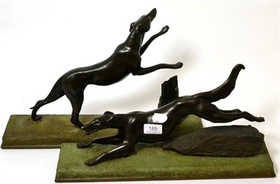 Lot 185 - A pair of spelter figures of greyhounds, 20th century, each running above a rocky green mossy base