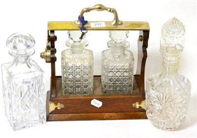 Lot 217 - An oak and silver plate two bottle tantalus and two further decanters