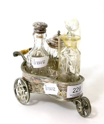 Lot 229 - A novelty silver plated cruet set in the form of a three wheeled cart