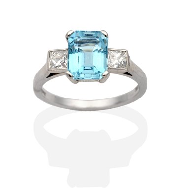Lot 326 - An 18 Carat White Gold Aquamarine and Diamond Three Stone Ring, an octagonal cut aquamarine in...