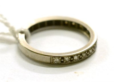 Lot 277 - A platinum and diamond half hoop eternity ring