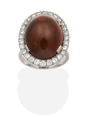 Lot 328 - An 18 Carat White Gold Opal and Diamond Cluster Ring, an oval cabochon dark red opal in a claw...