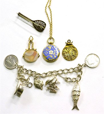 Lot 290 - An enamel hair locket on gold chain together with silver charm bracelet, swivel intaglio fob...